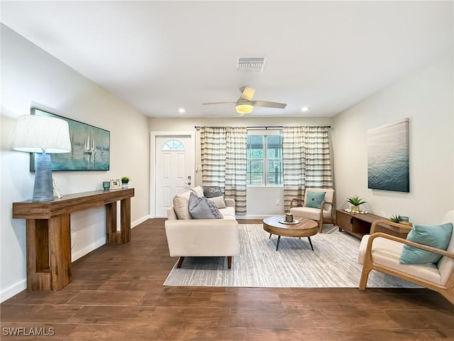 living room featuring dark hardwood / wood-style flooring and ceiling fan