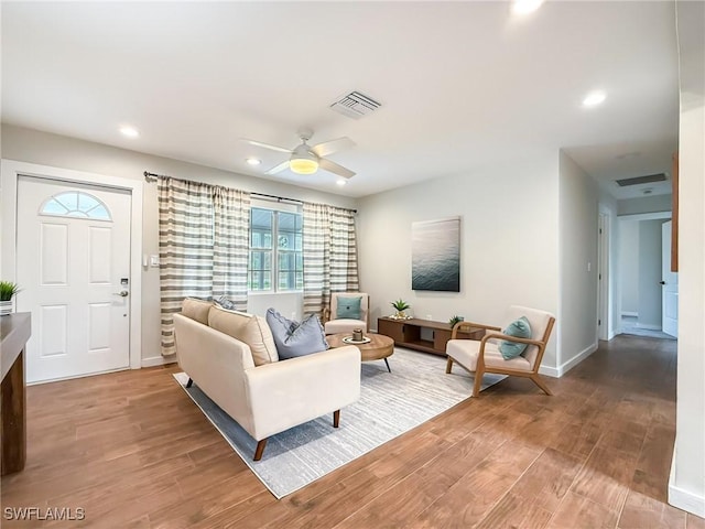 living room featuring hardwood / wood-style flooring and ceiling fan