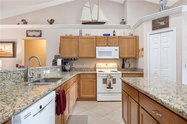 kitchen featuring vaulted ceiling, sink, light tile patterned floors, light stone counters, and white appliances