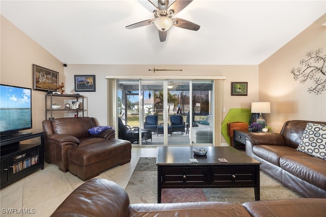 living room with light tile patterned flooring, ceiling fan, and vaulted ceiling