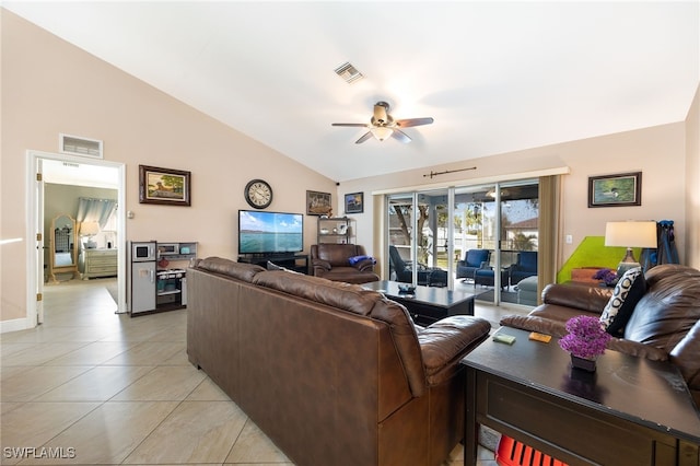 living room featuring lofted ceiling, light tile patterned floors, and ceiling fan