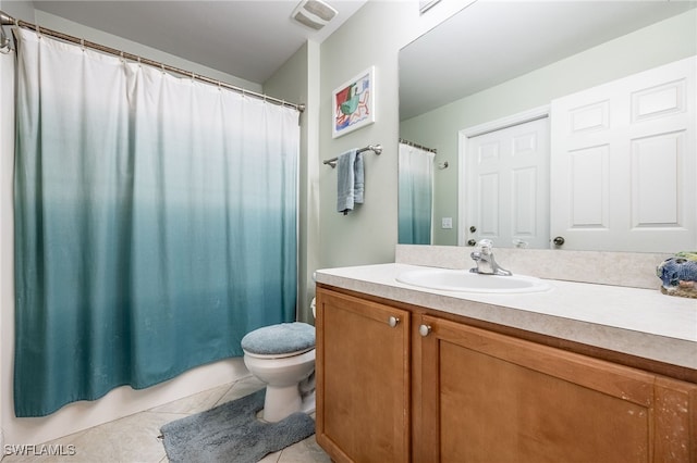 bathroom featuring vanity, toilet, and tile patterned flooring