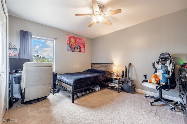 bedroom featuring light carpet and ceiling fan