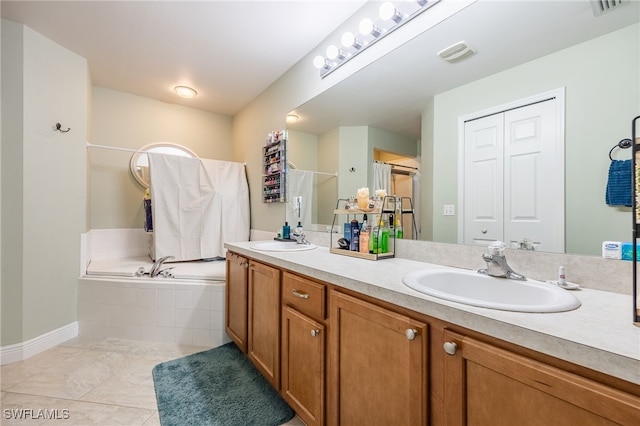 bathroom featuring tiled tub and vanity