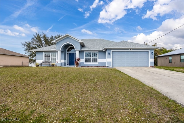 ranch-style house featuring a garage and a front lawn