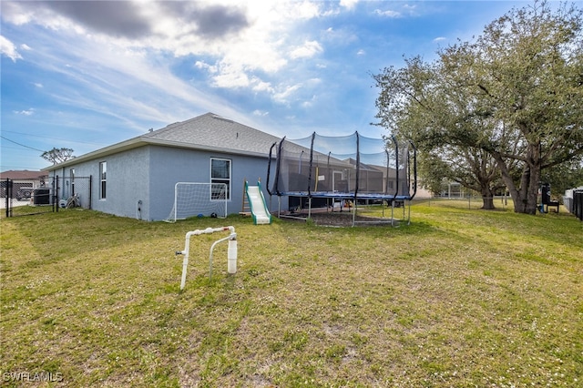 exterior space featuring a playground and a trampoline