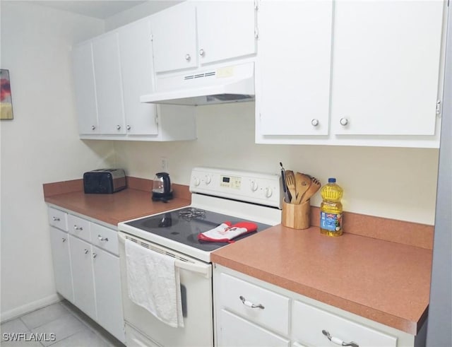 kitchen with light tile patterned floors, white cabinets, and white electric range oven