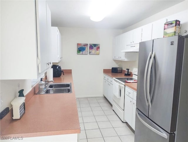 kitchen with sink, white cabinetry, light tile patterned floors, white electric stove, and stainless steel fridge