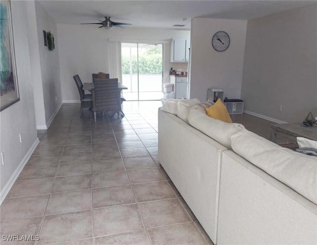 tiled living room featuring ceiling fan