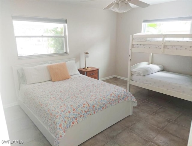 tiled bedroom featuring ceiling fan