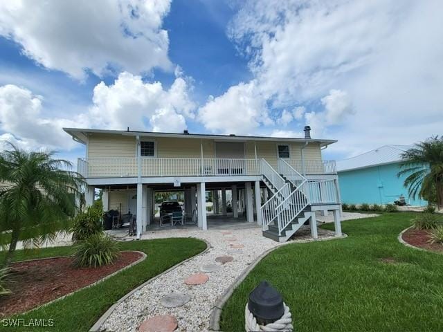 rear view of property featuring a carport and a lawn