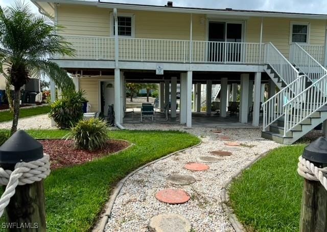 back of property with a carport and covered porch