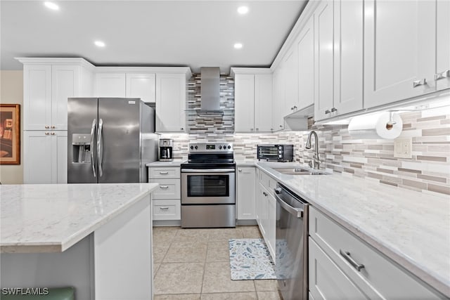 kitchen featuring white cabinetry, sink, light stone countertops, and appliances with stainless steel finishes