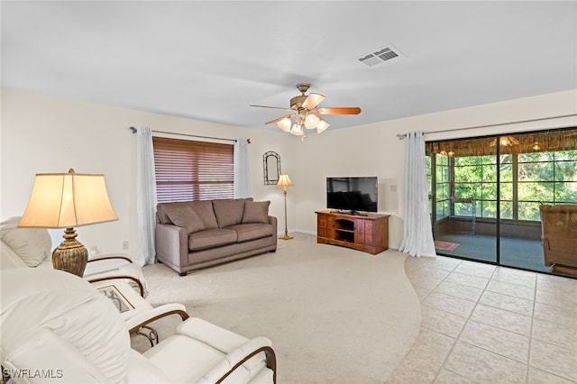 tiled living room with ceiling fan