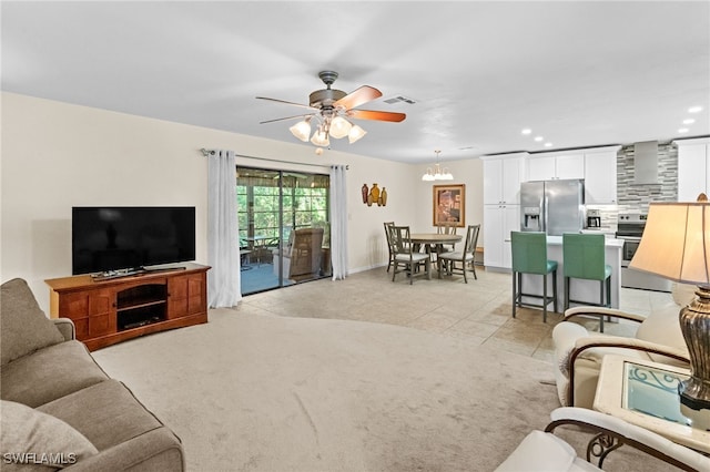 carpeted living room with ceiling fan