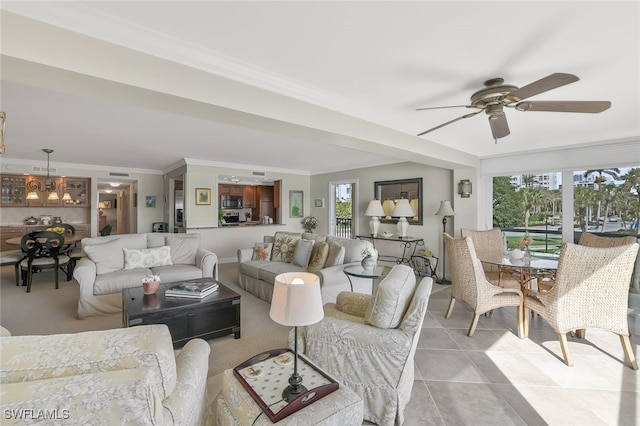 tiled living room with crown molding, ceiling fan, and a wealth of natural light