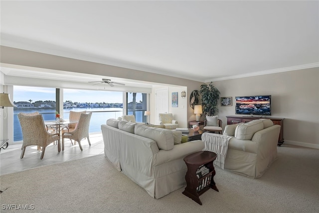 tiled living room with ornamental molding and ceiling fan