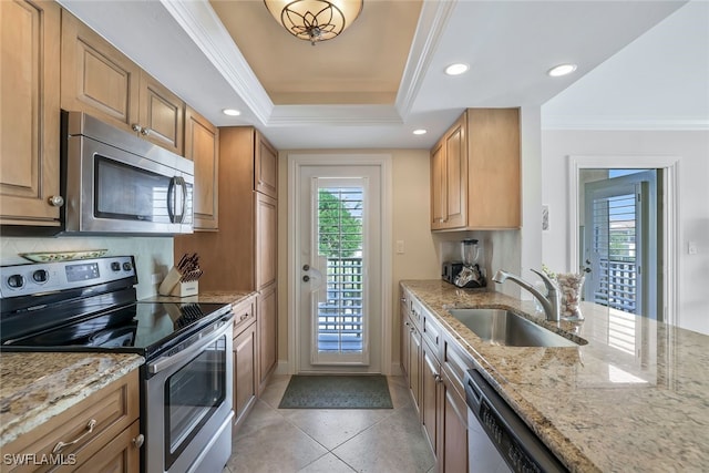 kitchen featuring ornamental molding, appliances with stainless steel finishes, sink, and a wealth of natural light