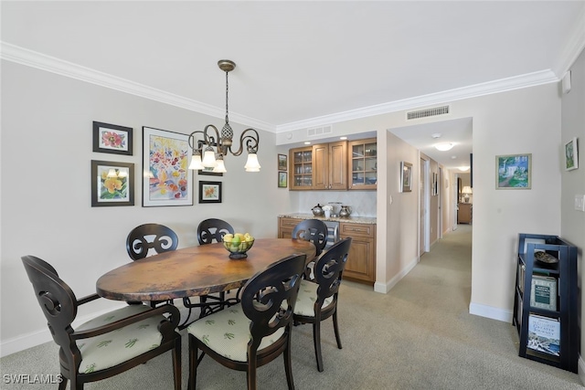 dining room featuring crown molding, light carpet, and a notable chandelier