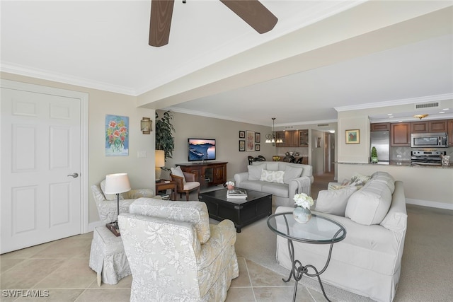 living room with ornamental molding, light tile patterned floors, and ceiling fan