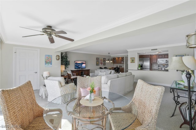 dining room with ornamental molding and ceiling fan