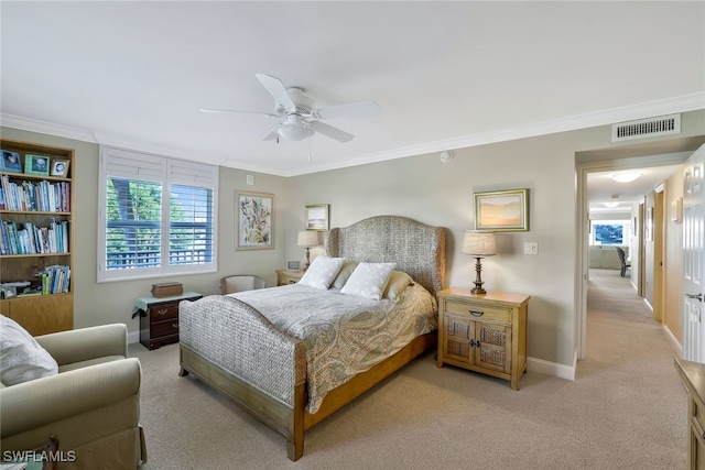 bedroom featuring crown molding, light carpet, and ceiling fan