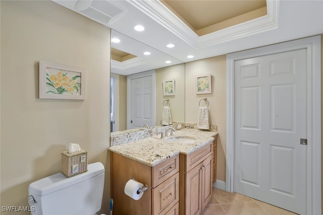 bathroom featuring tile patterned floors, vanity, toilet, and a raised ceiling