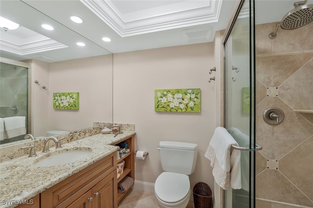 bathroom featuring vanity, a tray ceiling, a shower with shower door, and toilet