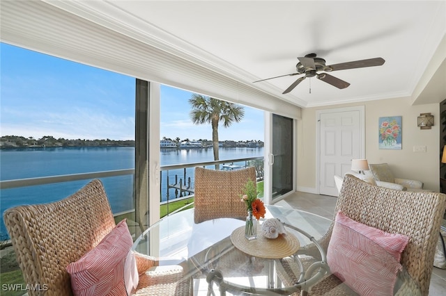 interior space with ceiling fan and a water view