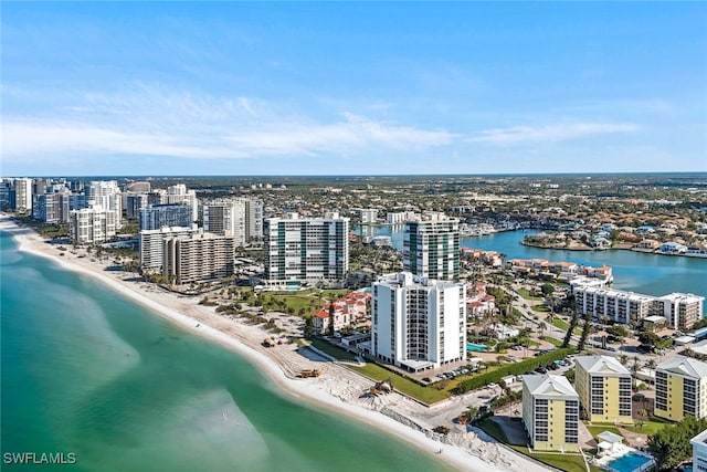 bird's eye view with a water view and a beach view