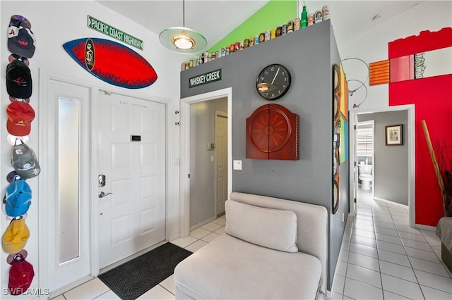 entryway with lofted ceiling and light tile patterned floors