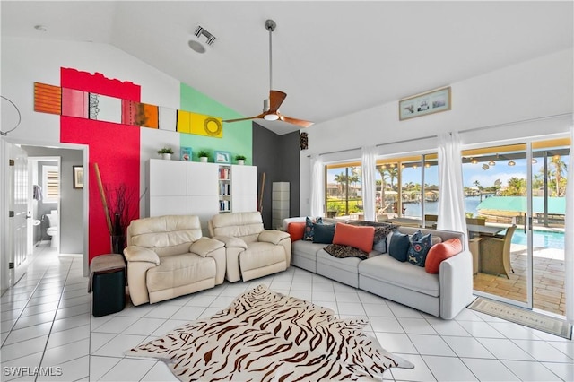 living room featuring high vaulted ceiling, light tile patterned flooring, ceiling fan, and a water view