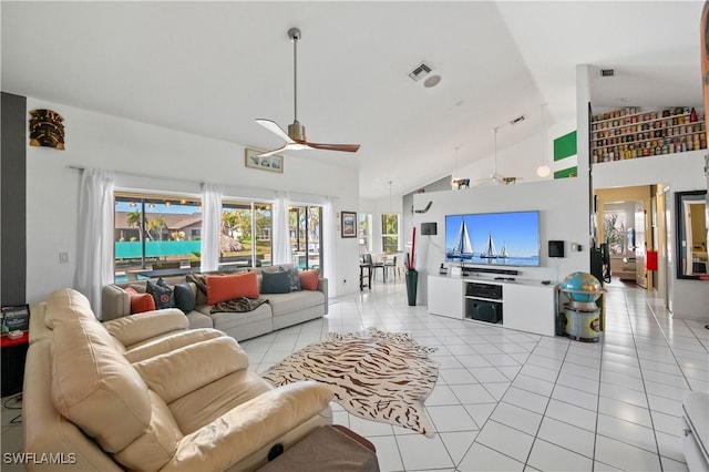 tiled living room with ceiling fan and high vaulted ceiling