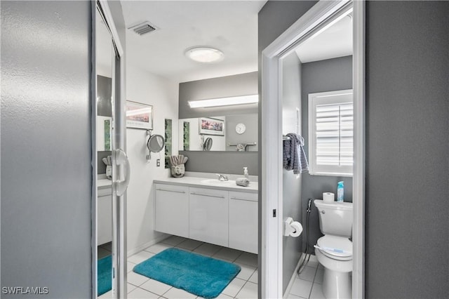 bathroom with vanity, tile patterned floors, and toilet