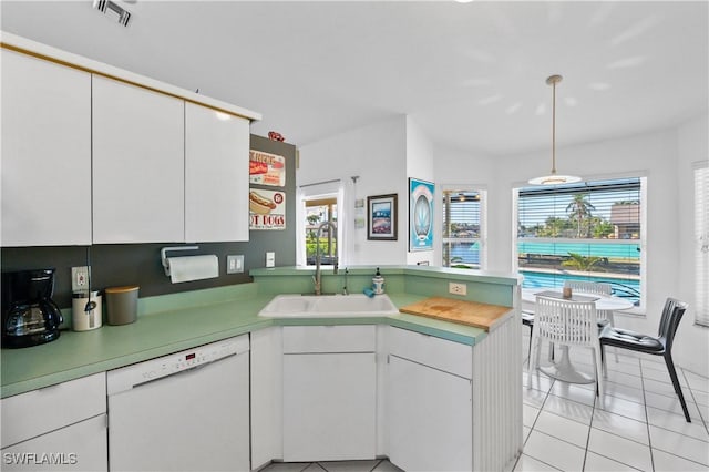 kitchen with sink, white cabinetry, white dishwasher, light tile patterned flooring, and kitchen peninsula