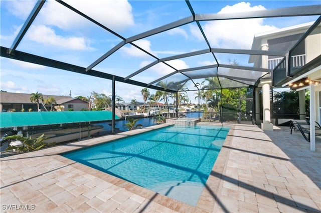 view of swimming pool featuring a patio, a water view, and glass enclosure