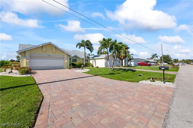 view of front of property with a garage and a front lawn