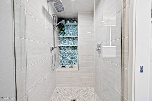 bathroom with a tile shower