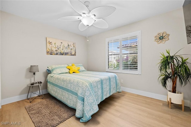 bedroom with light hardwood / wood-style flooring and ceiling fan