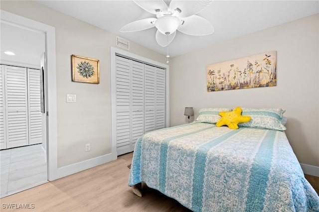 bedroom with wood-type flooring, ceiling fan, and a closet