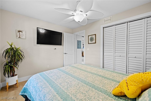 bedroom with hardwood / wood-style flooring, a closet, and ceiling fan