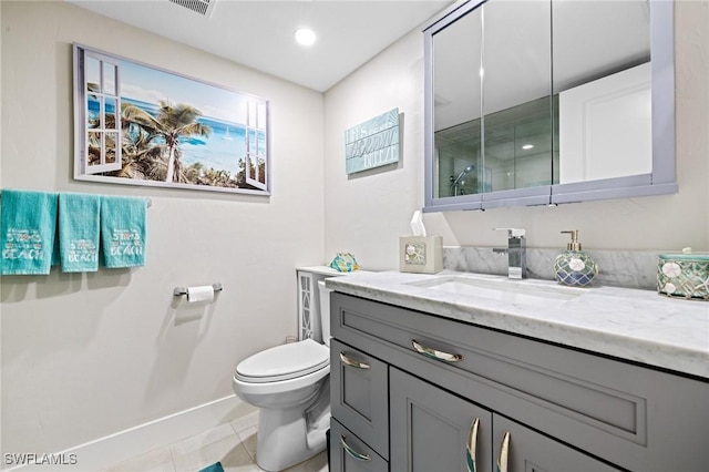 bathroom featuring vanity, toilet, and tile patterned flooring