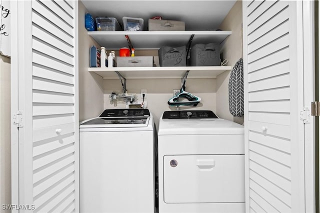 clothes washing area with washing machine and clothes dryer