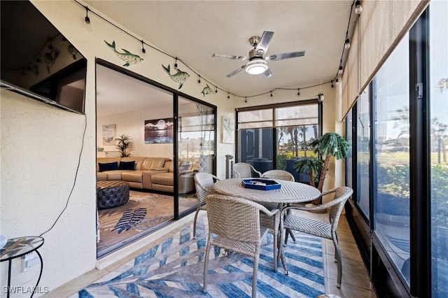 sunroom / solarium featuring ceiling fan