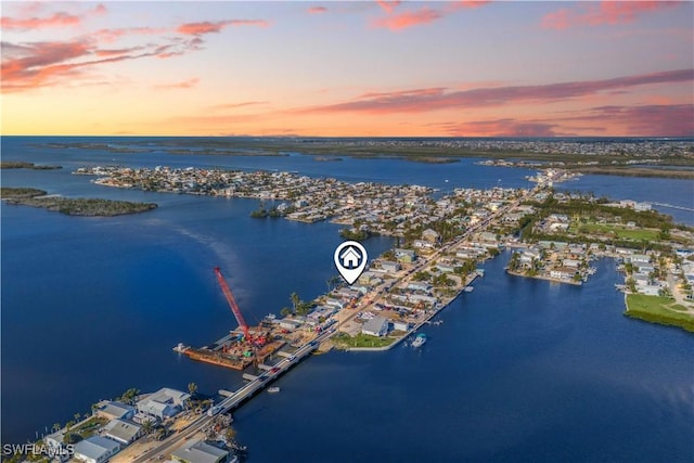 aerial view at dusk with a water view