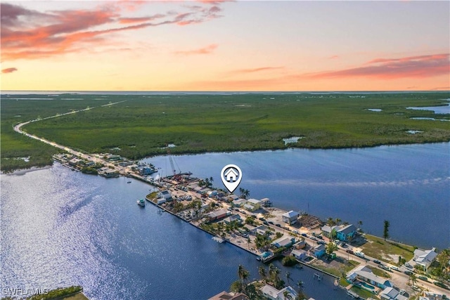 aerial view at dusk with a water view