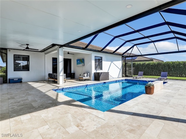view of swimming pool featuring ceiling fan, a fenced in pool, glass enclosure, and a patio area