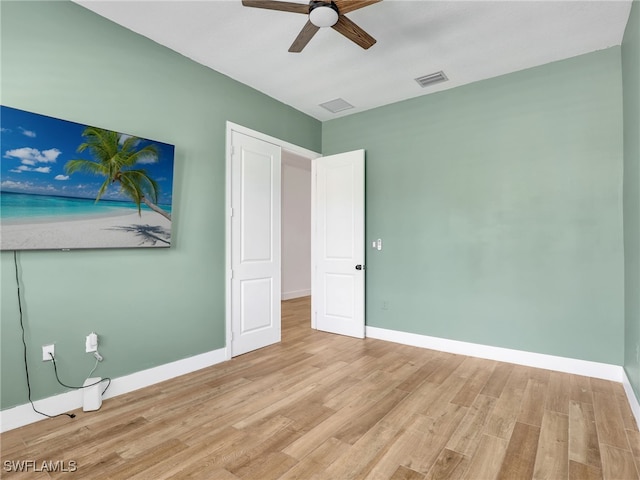 unfurnished bedroom with light wood-style flooring, visible vents, a ceiling fan, and baseboards