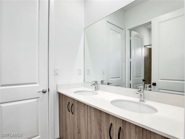 full bathroom featuring a sink and double vanity