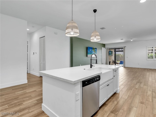 kitchen featuring open floor plan, light wood-type flooring, baseboards, and stainless steel dishwasher